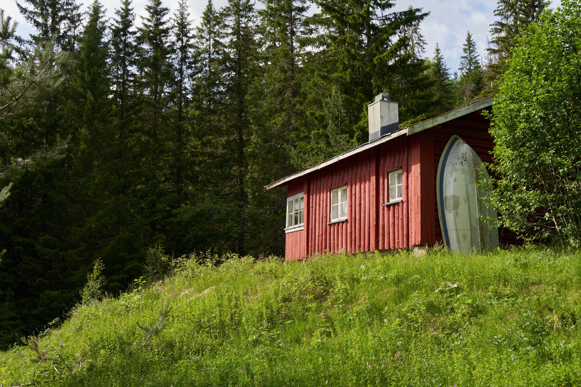 Nordic timber cabin in mountain landscape